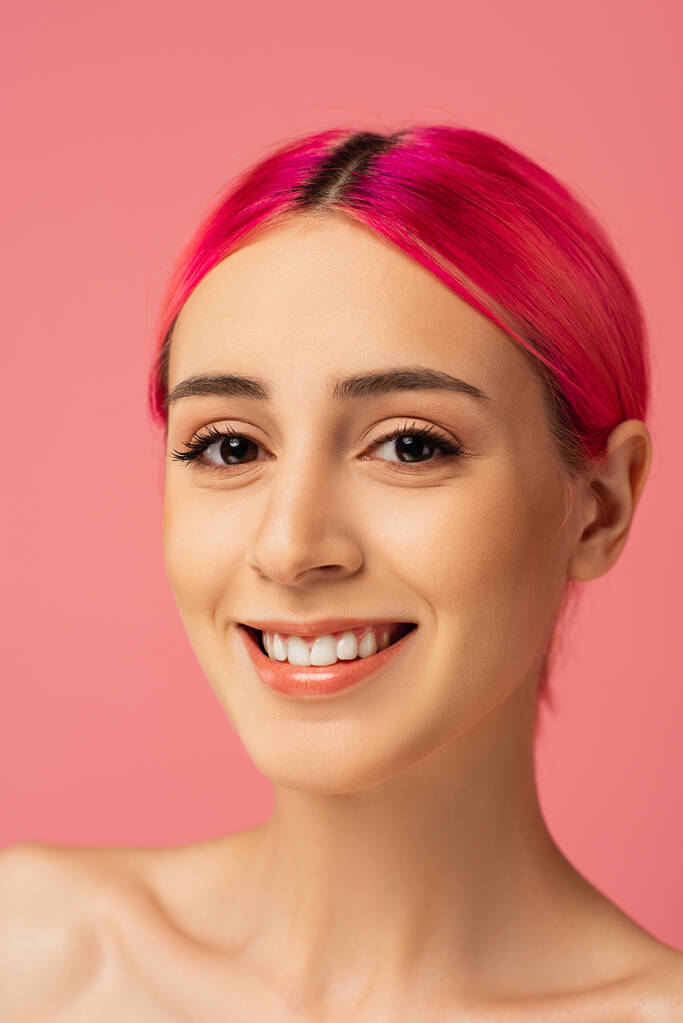 cheerful young woman with colorful hair smiling isolated on pink  - Photo, Image