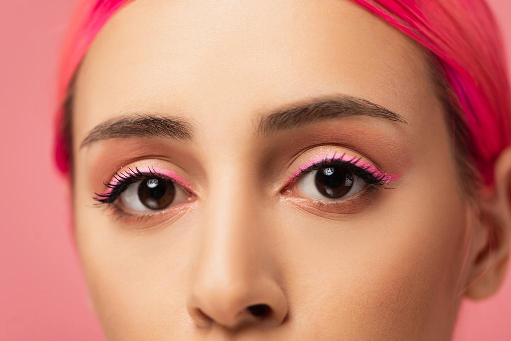 close up of cropped young woman with colorful hair looking at camera isolated on pink  - Photo, Image