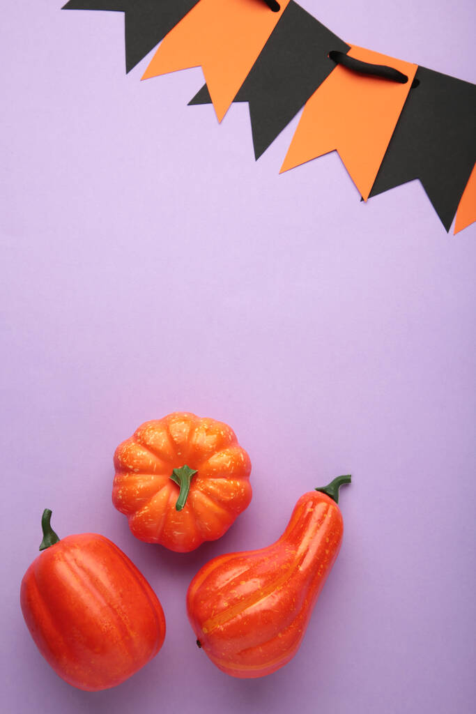 Halloween composition with pumpkins on purple background. Top view - Photo, Image