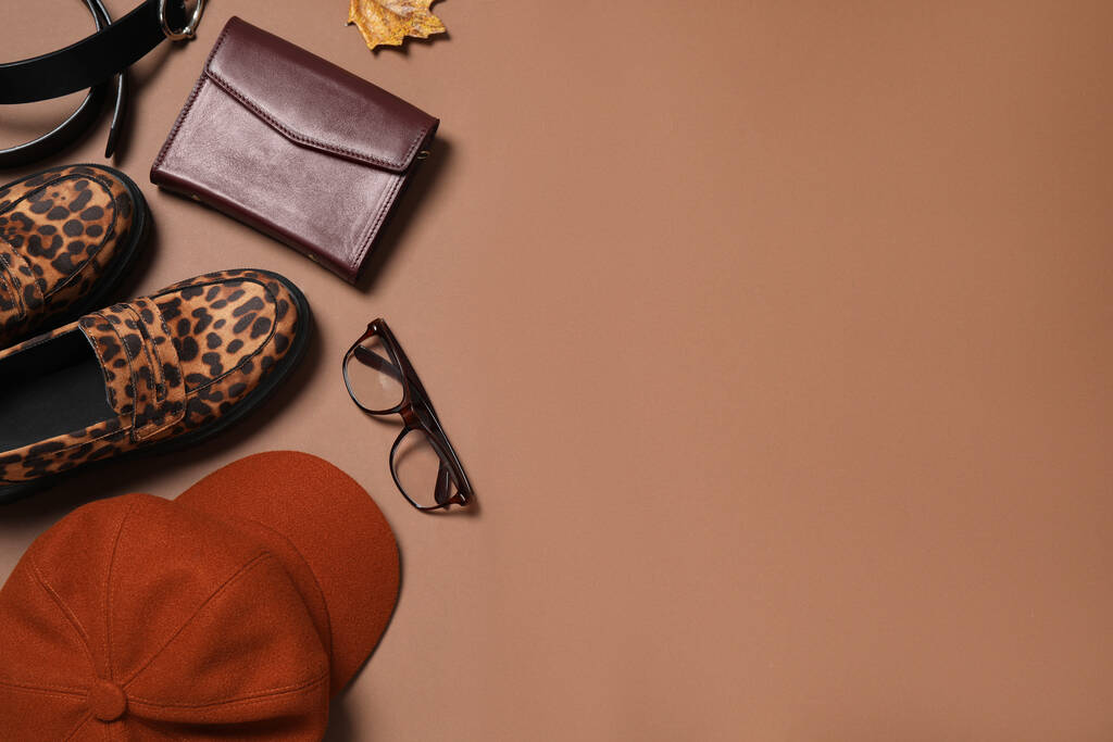 Flat lay composition with stylish hat on brown background, space for text - Photo, Image