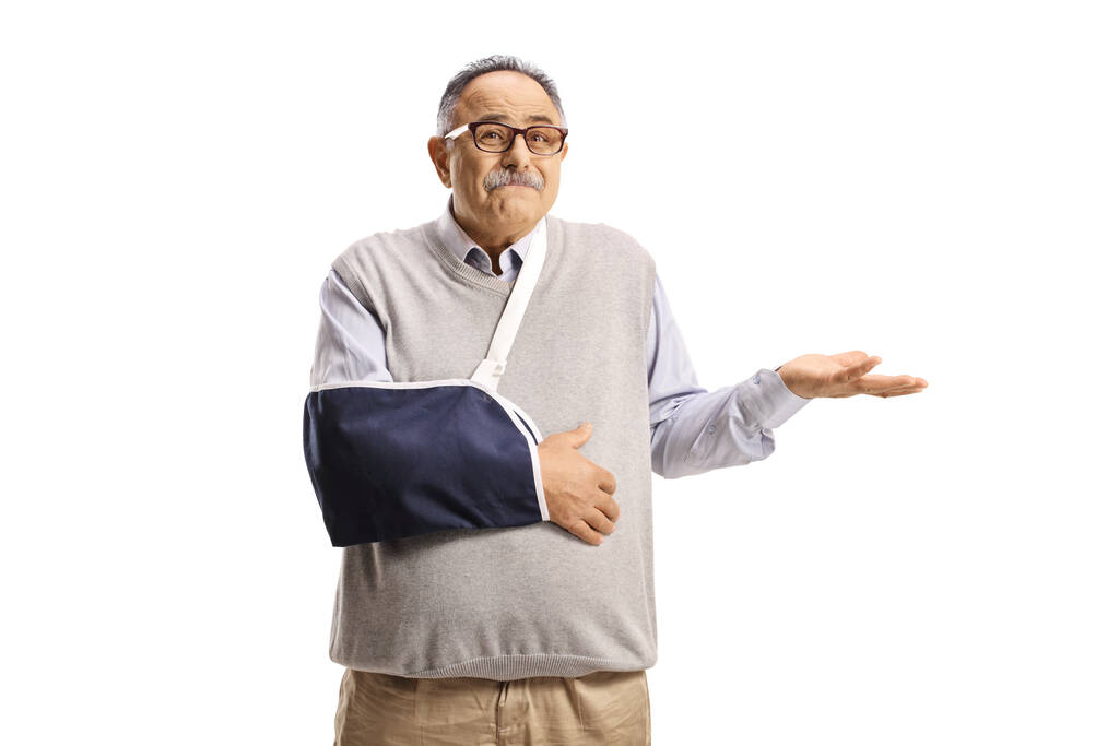 Zmatený zralý muž se zlomenou rukou nosí dlahu izolované na bílém pozadí - Fotografie, Obrázek