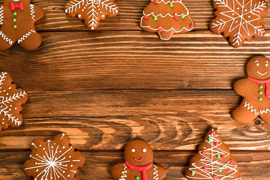 flat lay with gingerbread cookies on wooden surface - Photo, Image