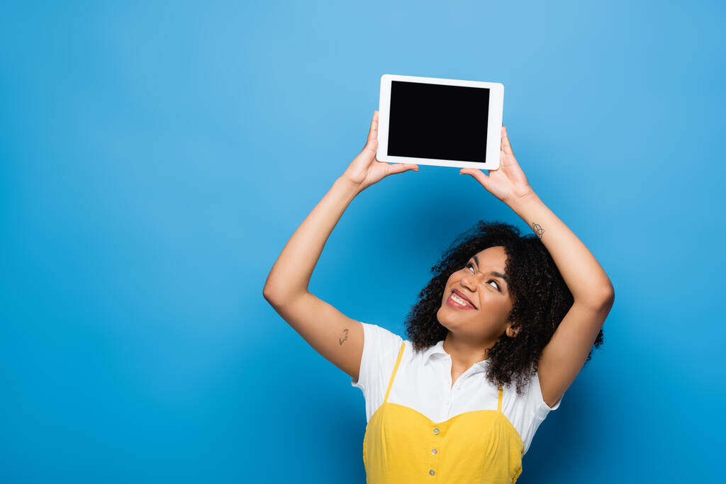 feliz mulher afro-americana segurando tablet digital com tela em branco no azul - Foto, Imagem