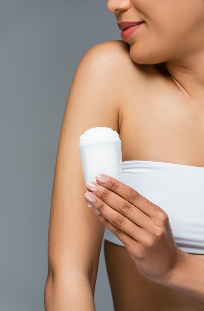 cropped view of african american woman in white top holding dry antiperspirant isolated on grey - Photo, Image