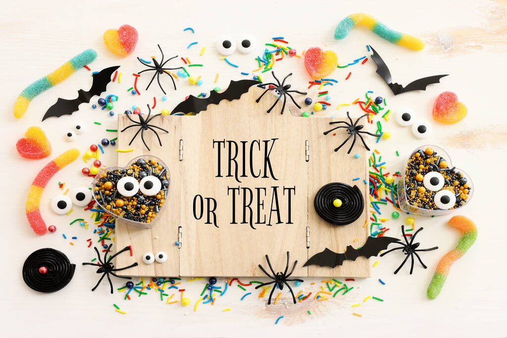 holidays image of Halloween. bats, spiders and wooden board frame with text over white table - Photo, Image