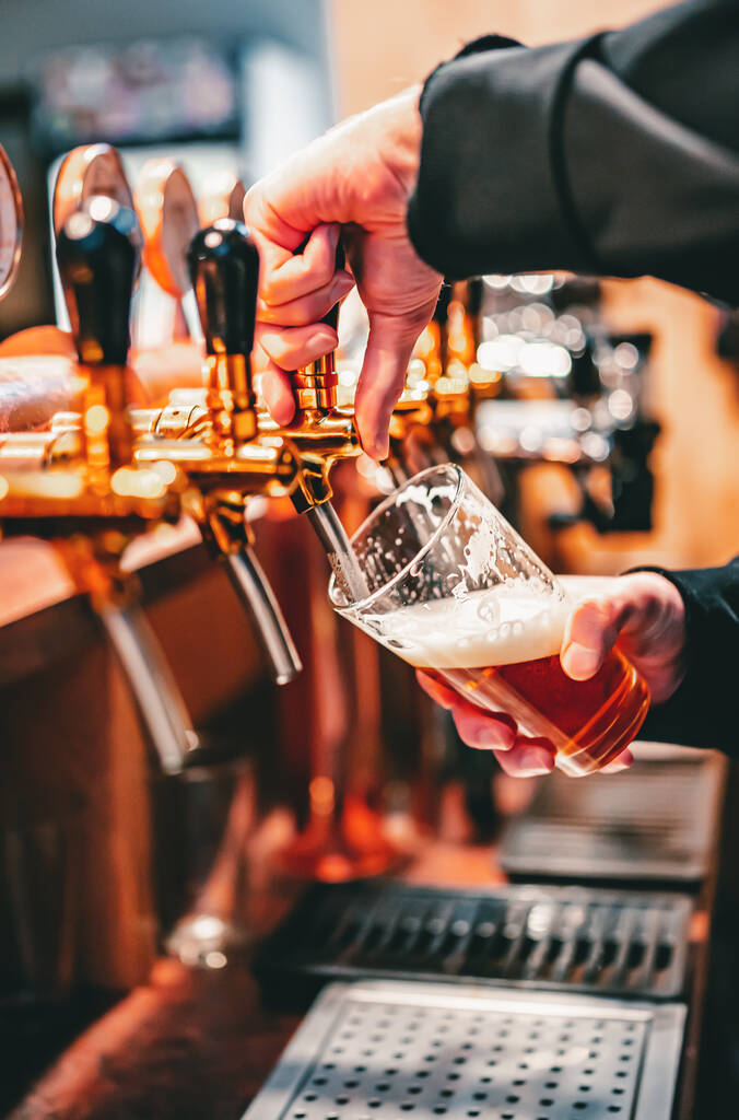 baarimikko käsi oluen hana kaatamalla syväys olutta lasi tarjoillaan baarissa tai pubissa - Valokuva, kuva