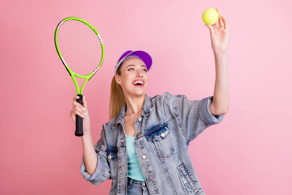 Photo of funky blond millennial lady play tennis wear blue top jacket visor isolated on pink color background - Photo, Image