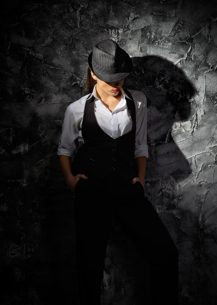 Woman with hat on grey wall - Photo, Image