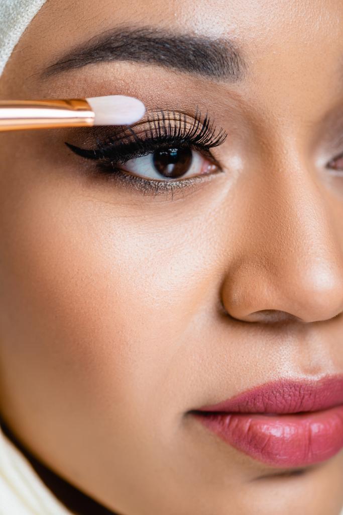 close up of muslim woman applying eye shadow with cosmetic brush - Photo, Image