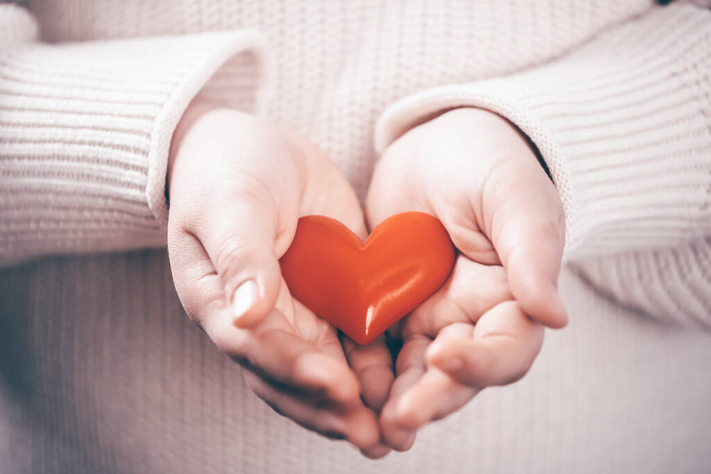 Child hands holding red heart. Healthcare, love, organ donation, mindfulness, wellbeing, world heart day, world health day concept. - Photo, Image