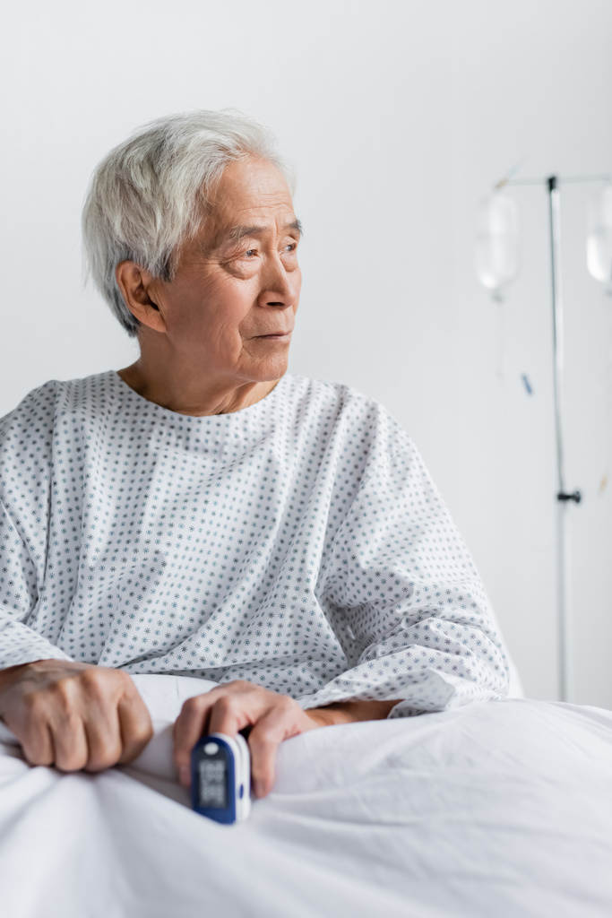 Pacjent w podeszłym wieku z azjatyckim pulsoksymetrem na oddziale szpitalnym  - Zdjęcie, obraz