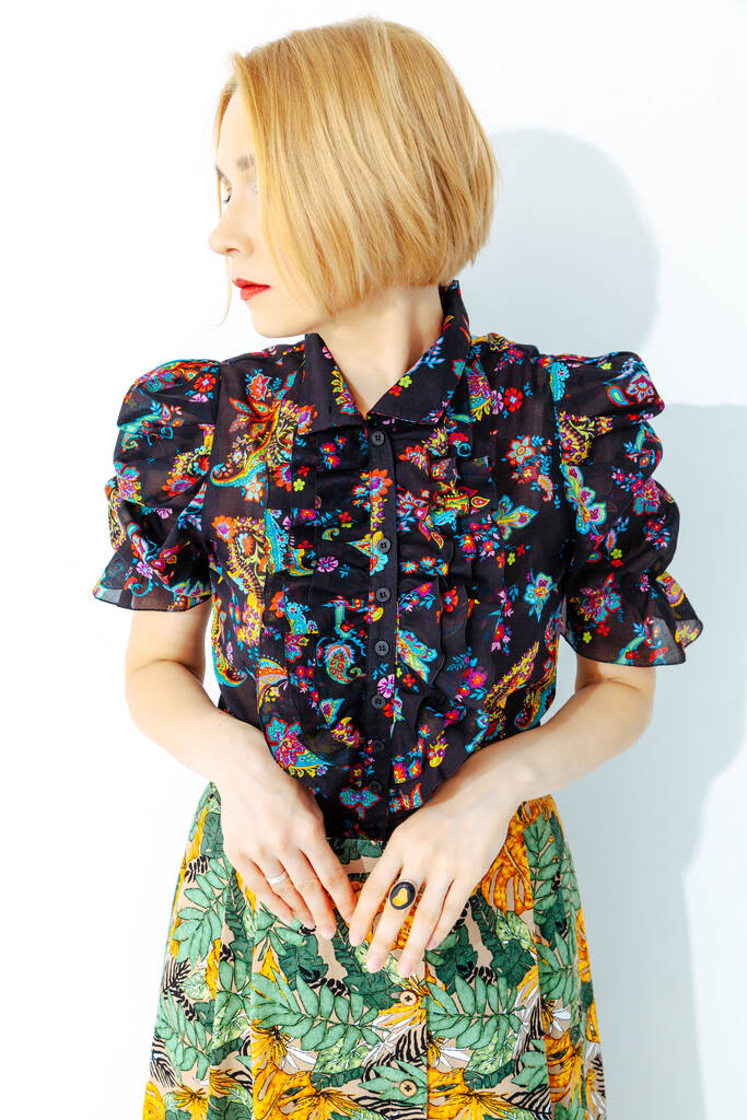 Stylish blonde with short hair in a short sleeve blouse on a white backgroun - Photo, Image