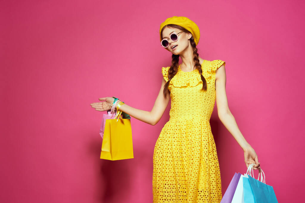 λαμπερό γυναίκα σε ένα κίτρινο καπέλο Shopaholic στυλ μόδας απομονωμένο φόντο - Φωτογραφία, εικόνα