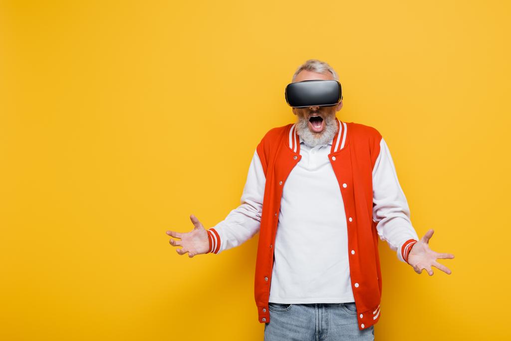 shocked middle aged man in bomber jacket and vr headset on yellow - Photo, Image