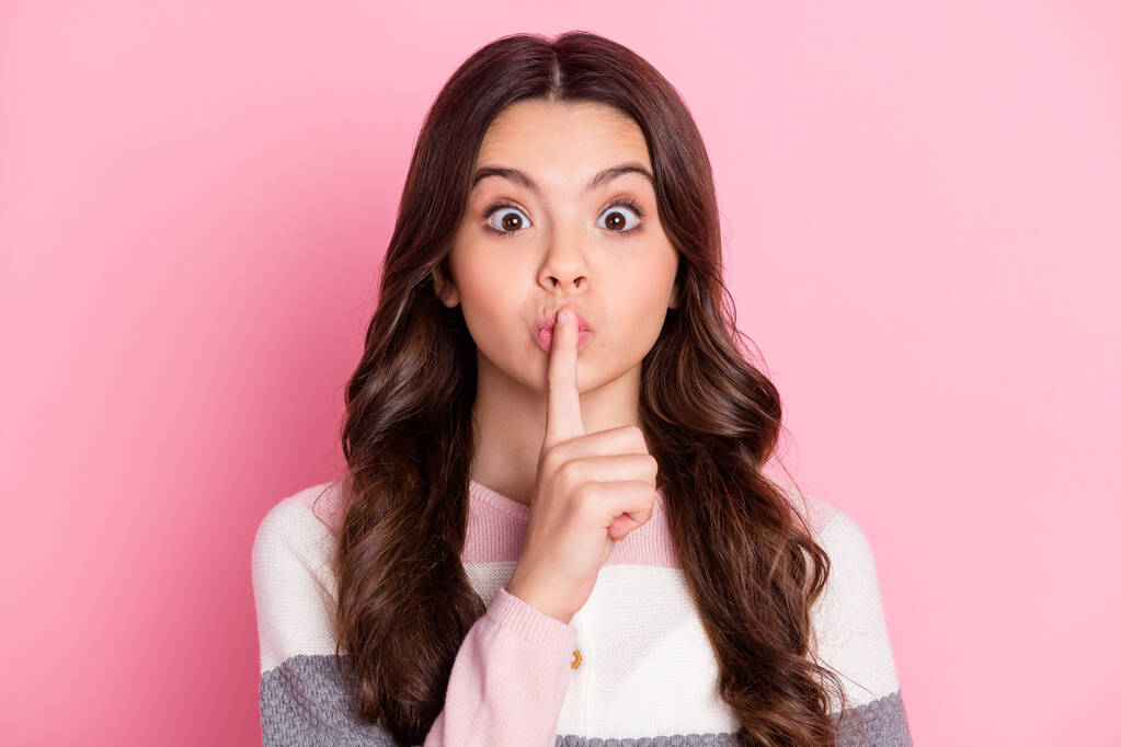 Photo of young preteen girl cover finger lips keep secret no talk rumor gossip private information isolated over pink color background - Photo, Image
