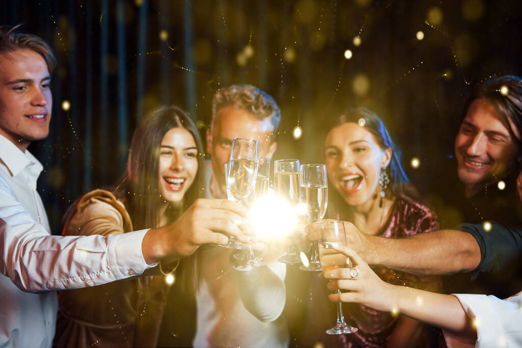 Gruppo di giovani allegri fanno festa e festeggiano il nuovo anno al chiuso. - Foto, immagini
