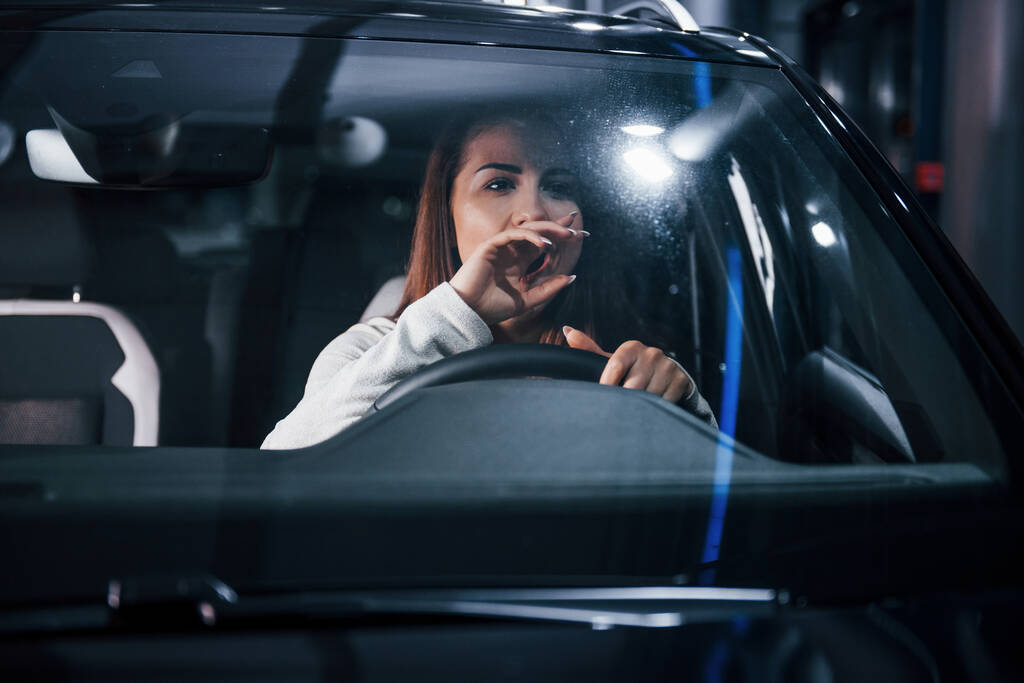 Young woman is inside of brand new modern automobile. - Photo, Image