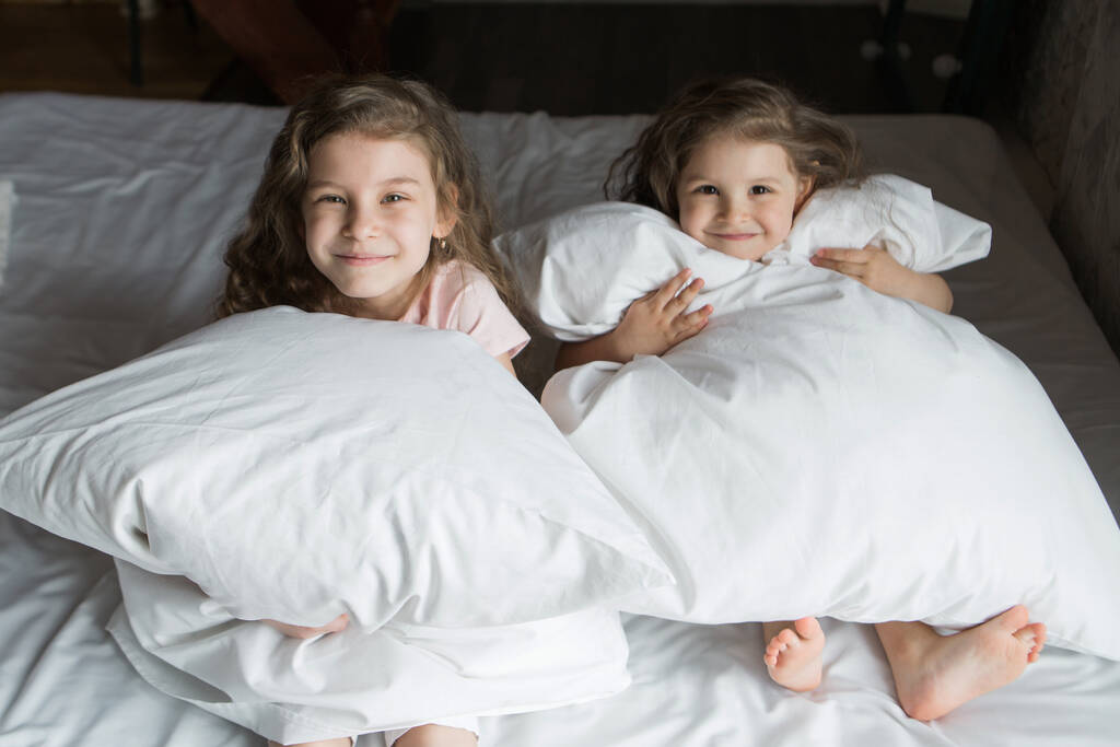 familia de la mañana: los niños jugando en la cama. Despertar de un sueño. Me acabo de despertar. amor - Foto, imagen