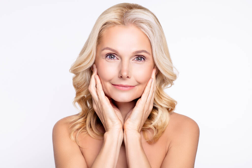 Portrait of attractive healthy grey-haired woman touching pure skin domestic facial massage isolated over white color background - Photo, Image
