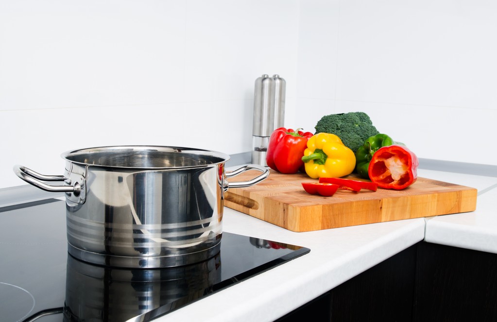 Γλάστρα και λαχανικά στη σύγχρονη κουζίνα με επαγωγικό φούρνο - Φωτογραφία, εικόνα