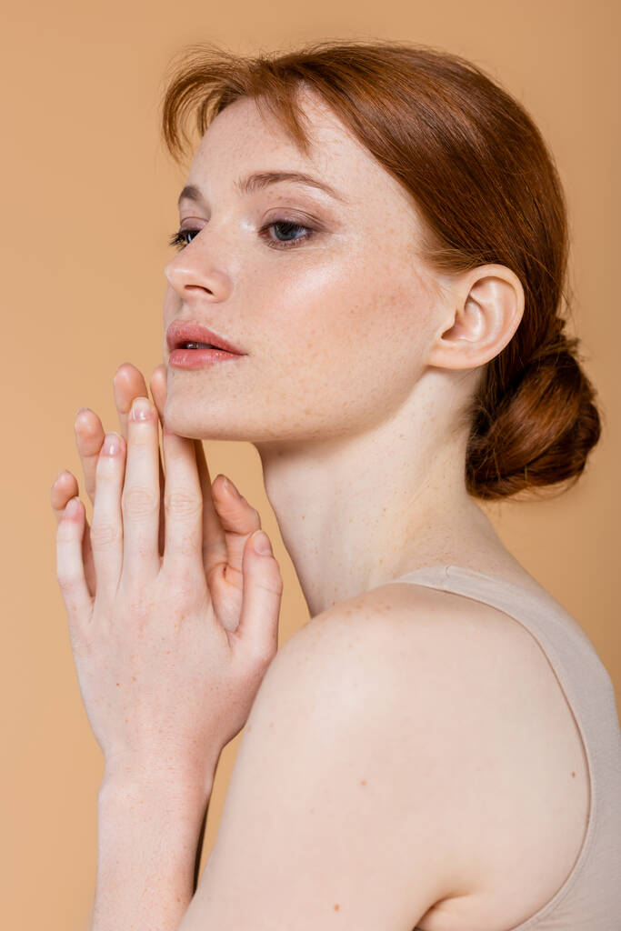 Red haired woman with clean skin posing isolated on beige  - Photo, Image