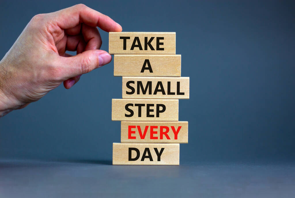 Take a small step every day symbol. Wooden blocks with words Take a small step every day. Beautiful grey background, copy space. Businessman hand. Business, step every day concept. - Photo, Image