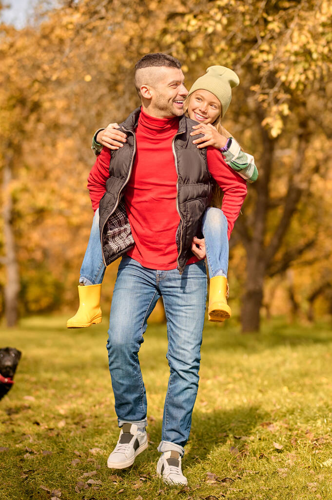 Папа и дочь играют в парке и выглядят счастливыми - Фото, изображение