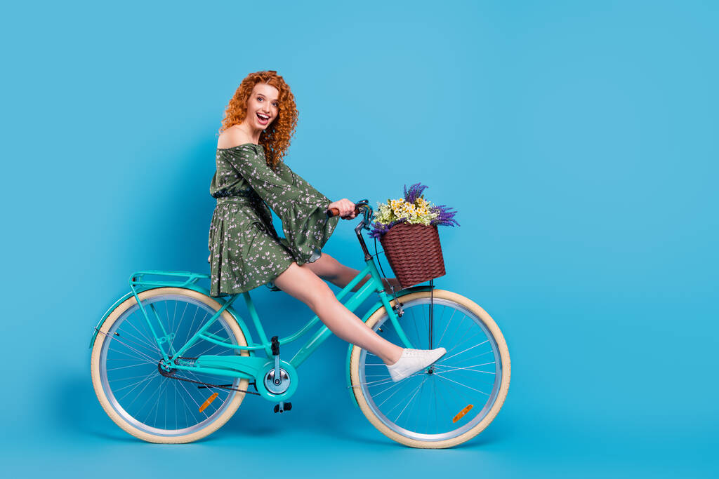 Full length profile photo of sweet lady ride bike wear dress sneakers isolated on blue color background - Photo, Image