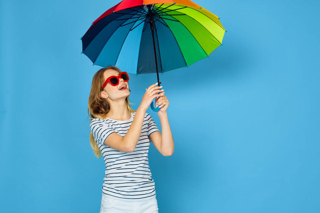pretty woman fashion posing colorful umbrella blue background - Photo, Image