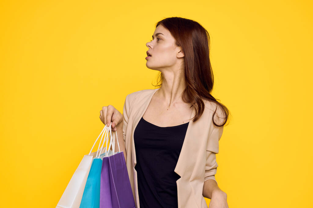 cheerful woman multicolored packs emotions shopping fashion yellow background - Photo, Image