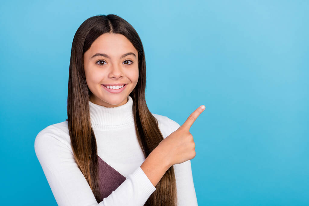 Photo of young pretty girl point finger empty space decision advert choose isolated over blue color background - Photo, Image