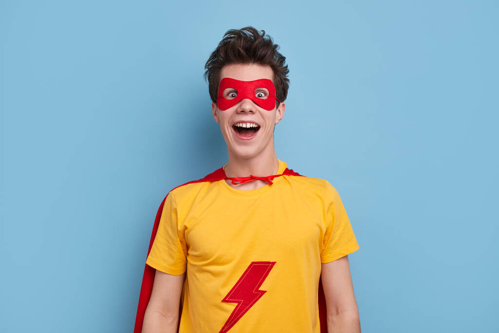 Excited man in superhero costume with mask - Photo, Image