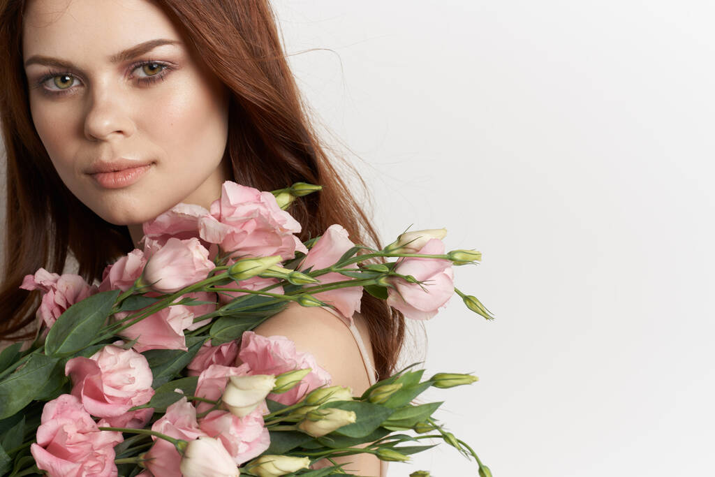 mooie vrouw in jurk poseren bloemen make-up geïsoleerde achtergrond - Foto, afbeelding