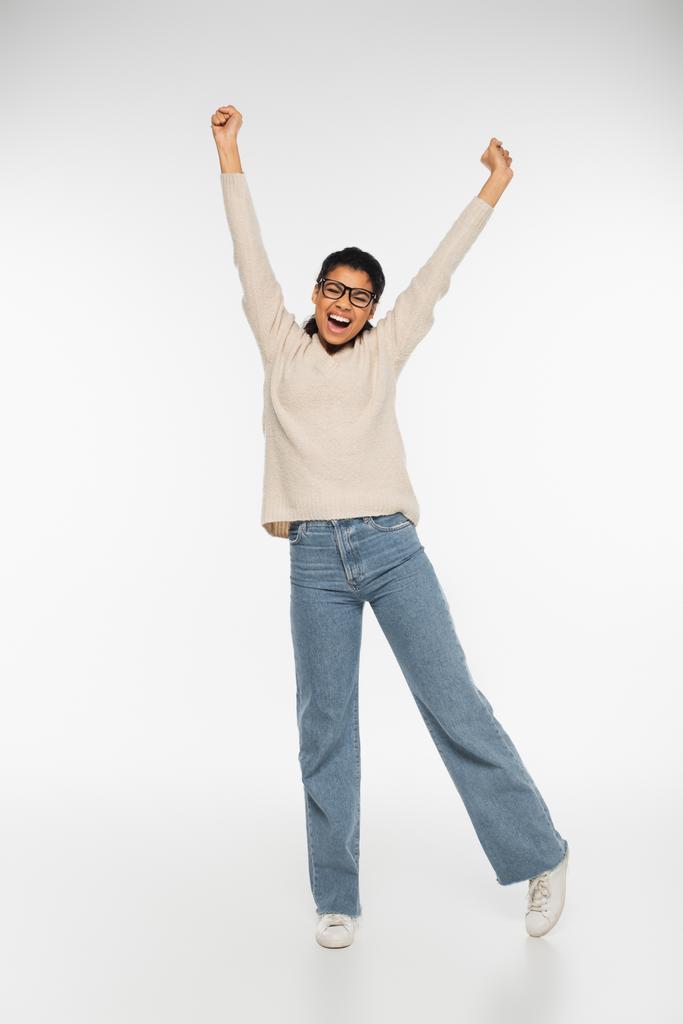 Excited african american woman in eyeglasses on white background  - Photo, Image