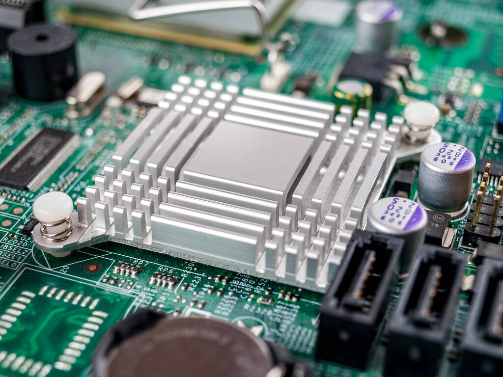 Metal aluminum radiator on the motherboard of a desktop computer, server, printed circuit board, electronic board, cooling - Photo, Image