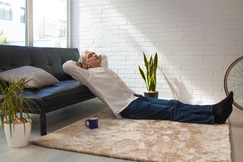 satisfied man relaxing in his living room - Photo, Image