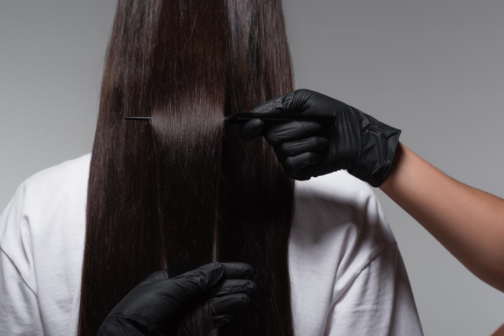 Gri renkli lateks eldivenli, pürüzsüz uzun saçlı genç bir kadının arka plan görüntüsü.  - Fotoğraf, Görsel