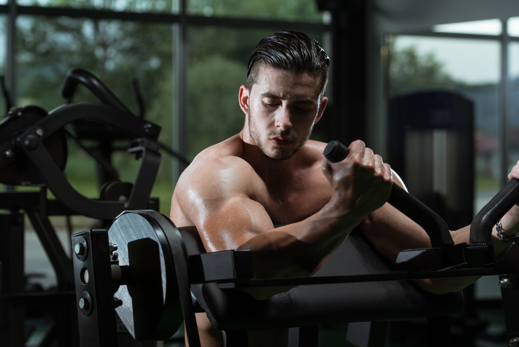 fiatal férfi csinál nehéz súlyú testmozgás bicepsz - Fotó, kép