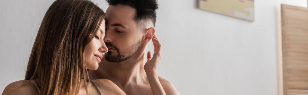 young and sexy lovers embracing with closed eyes in bedroom, banner - Foto, Imagem