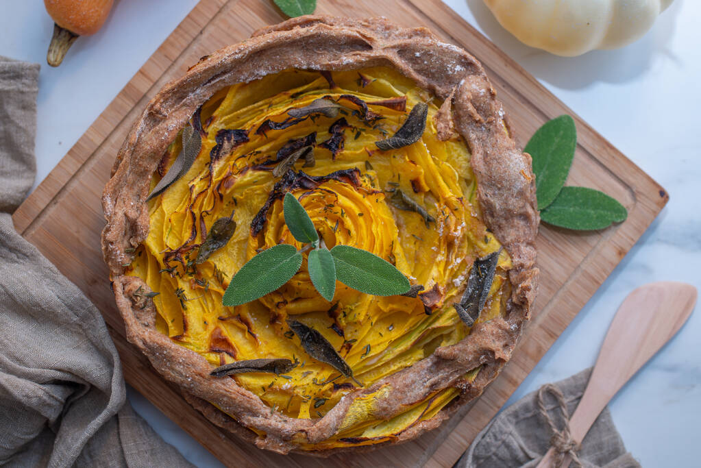 A homemade autumn quiche with pumpkin on the table - Photo, Image