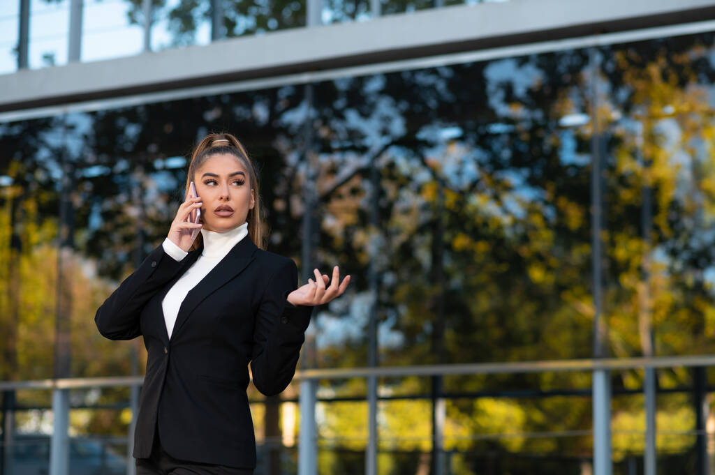 A Caucasian model with an elegant business suit talking on a mobile phone - Photo, Image