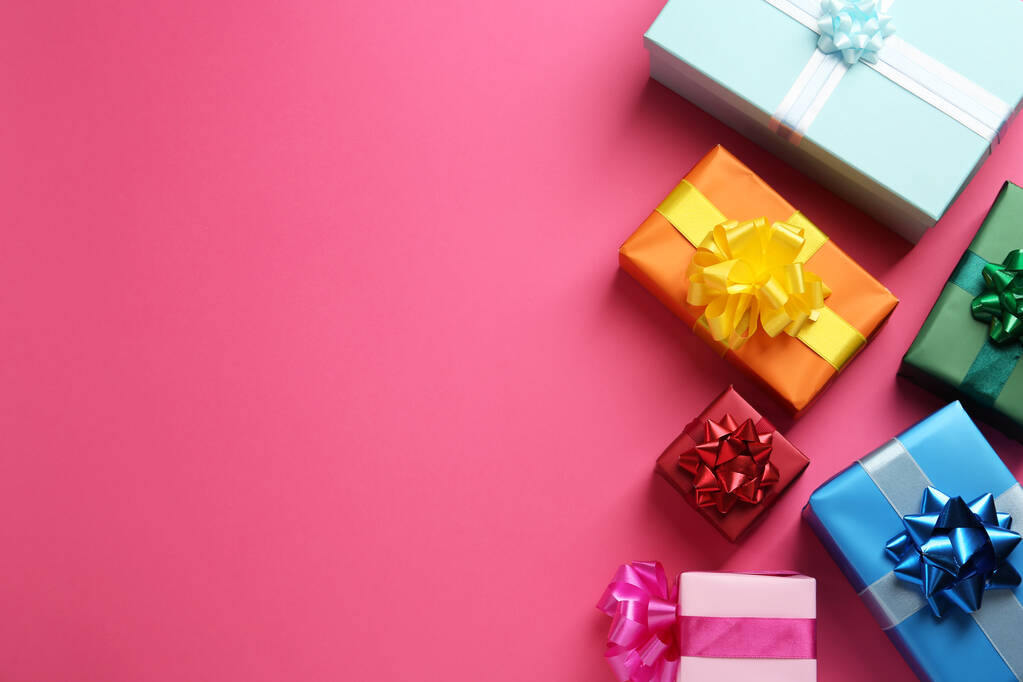 Molte scatole regalo colorate su sfondo rosa, posa piatta. Spazio per testo - Foto, immagini
