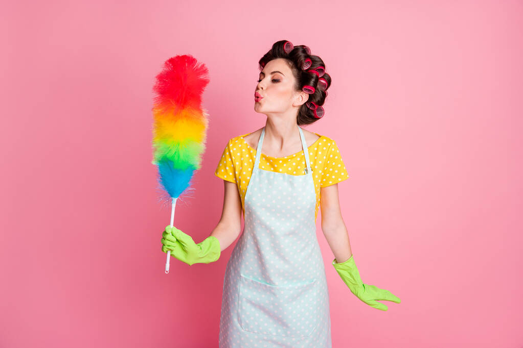 Photo of girl blow air soft duster brush wear yellow dotted t-shirt green gloves isolated over pastel color background - Photo, Image