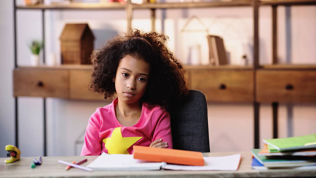 displeased african american child doing homework - Photo, Image