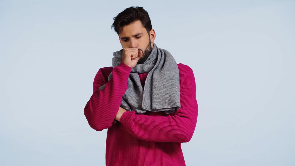 sick man in sweater and scarf coughing isolated on blue  - Foto, immagini