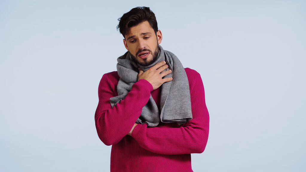 sick man in sweater and scarf having sore throat isolated on blue  - Photo, Image