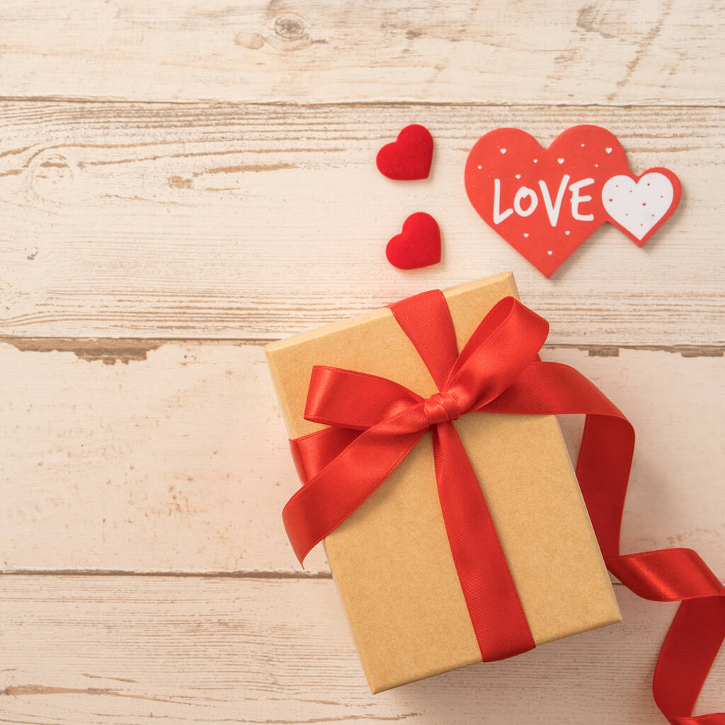 Kraft dárková krabička s červenou stuhou, koncept dárků a Valentýna, výročí, Den matek a narozeninové překvapení, byt ležel, pohled shora - Fotografie, Obrázek