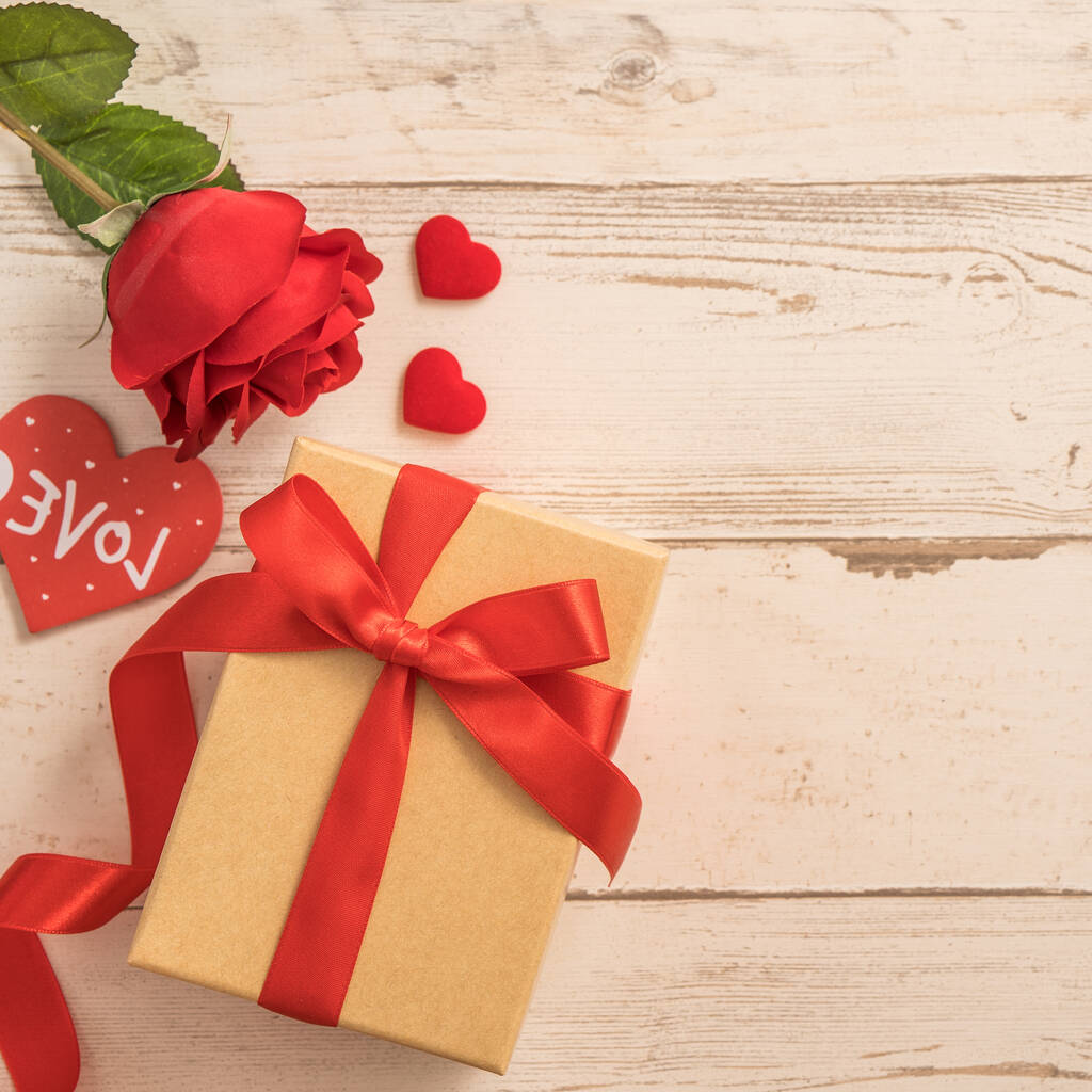 Kraft ajándékdoboz piros szalaggal íj, koncepció ajándékozás és Valentin-nap, évforduló, anyák napja és születésnapja meglepetés, lapos fektetés, felülnézet - Fotó, kép