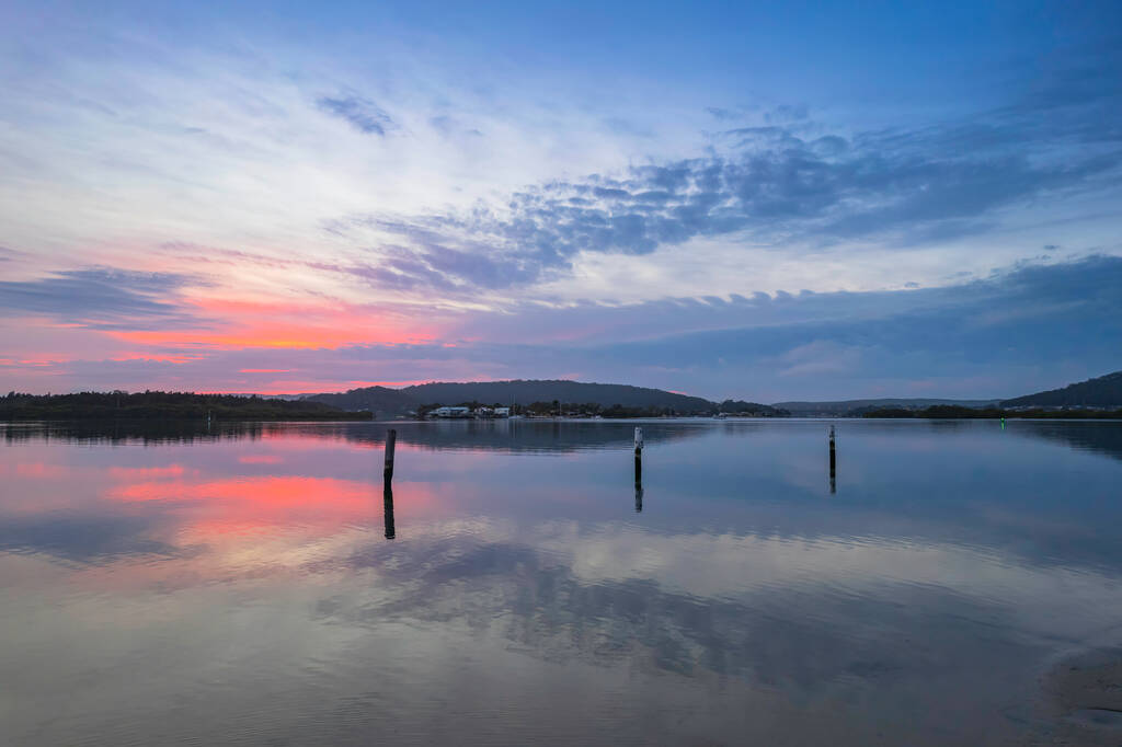 Восход солнца, облака и отражения на Вай-Вай-Набережной на Центральном побережье штата Нью-Йорк, Австралия. - Фото, изображение