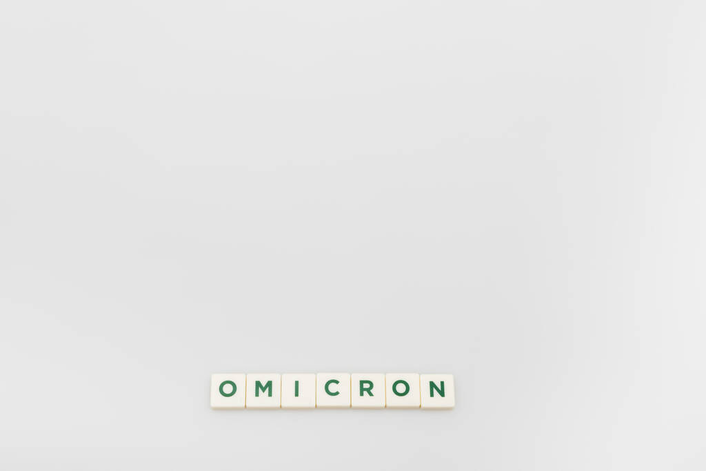 top view of white cubes with omicron lettering on grey background with copy space - Fotó, kép